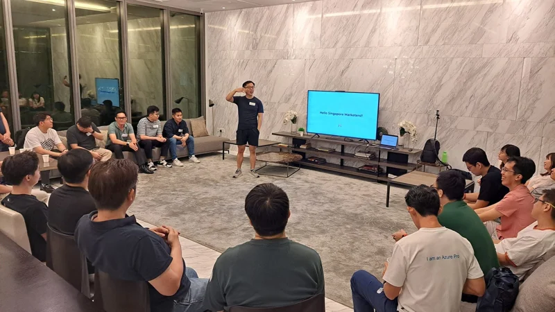 A wide view of Marc presenting to a seated audience.